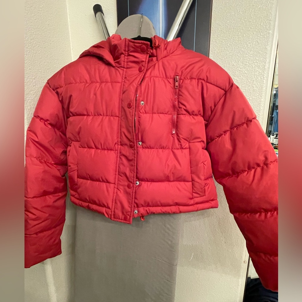 Red puffer jacket with hood.